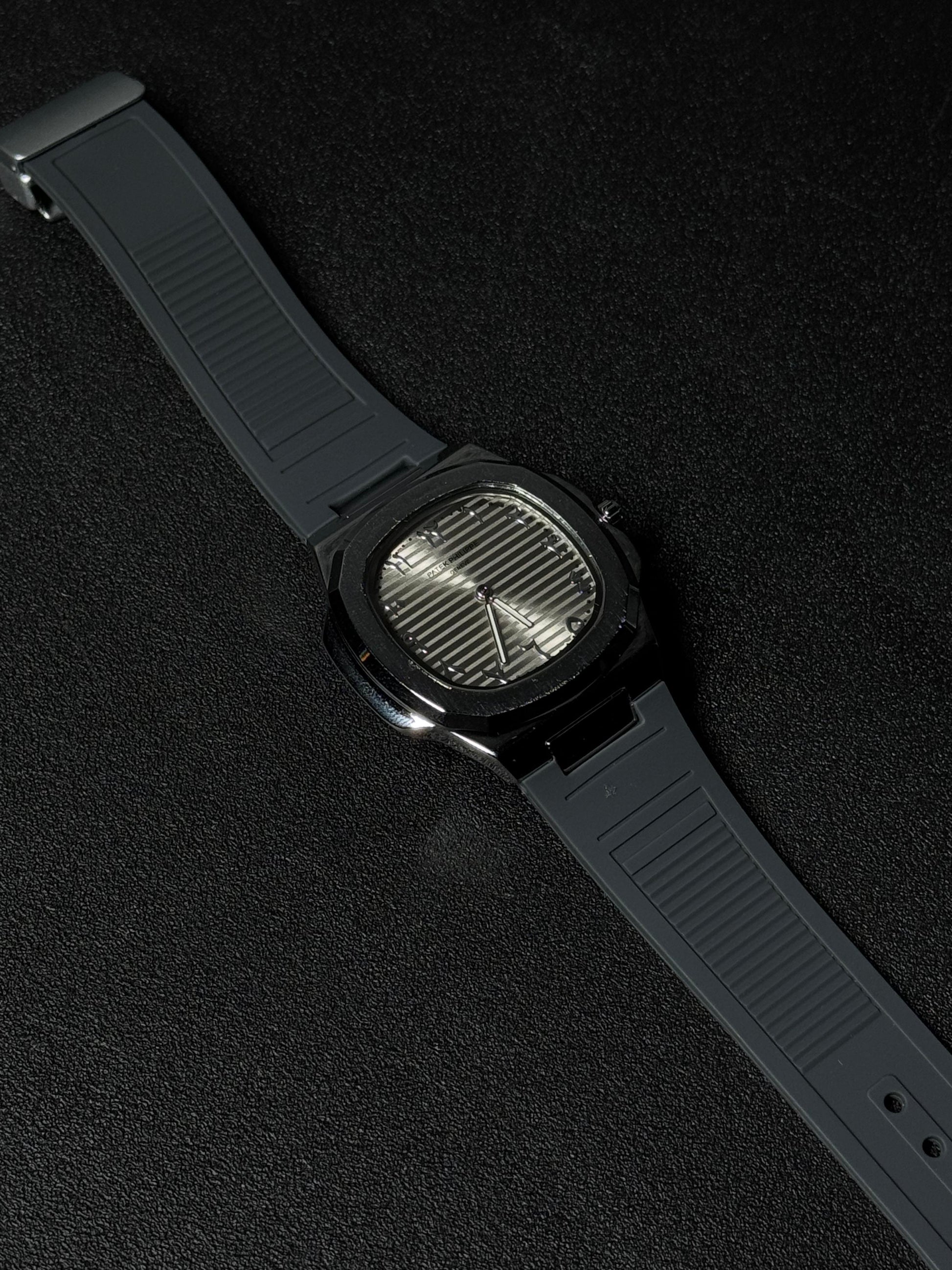 Black strap replica watch with textured dial, octagonal case design, luxury analog wristwatch and premium rubber strap on dark background