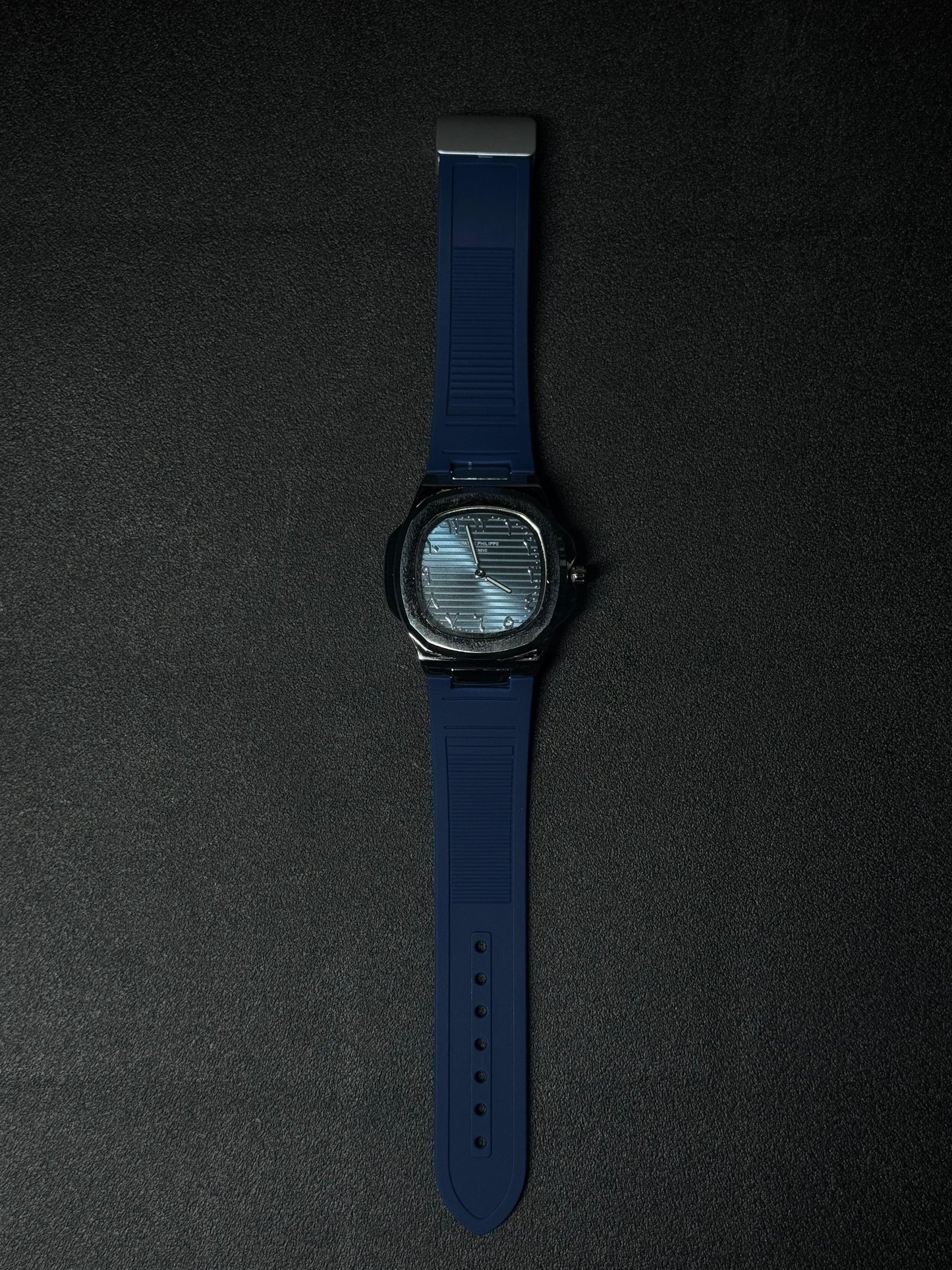 Blue strap replica watch featuring textured dial, luxury analog display, octagonal bezel design and premium silicone band