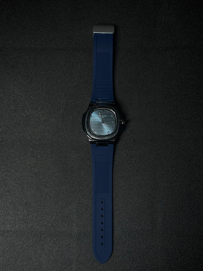 Blue strap replica watch featuring textured dial, luxury analog display, octagonal bezel design and premium silicone band