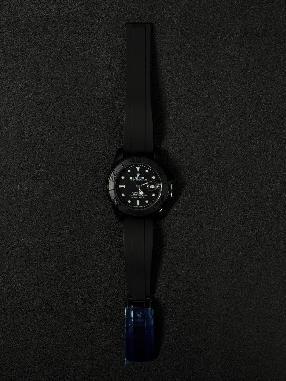 Three replica watch models styled after the Submariner with black dials and black rubber straps, featuring rose gold, silver stainless steel, and all-black cases.