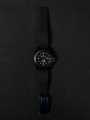 Three replica watch models styled after the Submariner with black dials and black rubber straps, featuring rose gold, silver stainless steel, and all-black cases.