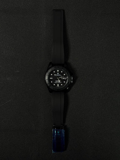 Three replica watch models styled after the Submariner with black dials and black rubber straps, featuring rose gold, silver stainless steel, and all-black cases.
