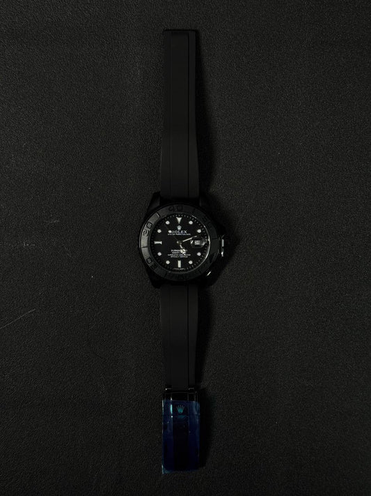 Three replica watch models styled after the Submariner with black dials and black rubber straps, featuring rose gold, silver stainless steel, and all-black cases.