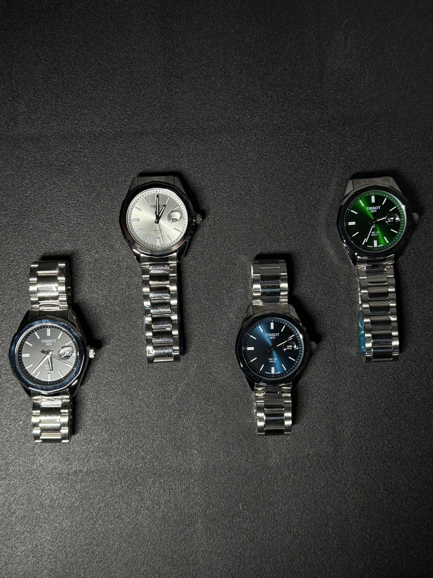 Replica watch collection featuring black, silver, blue and green dial stainless steel men's watches displayed on dark background