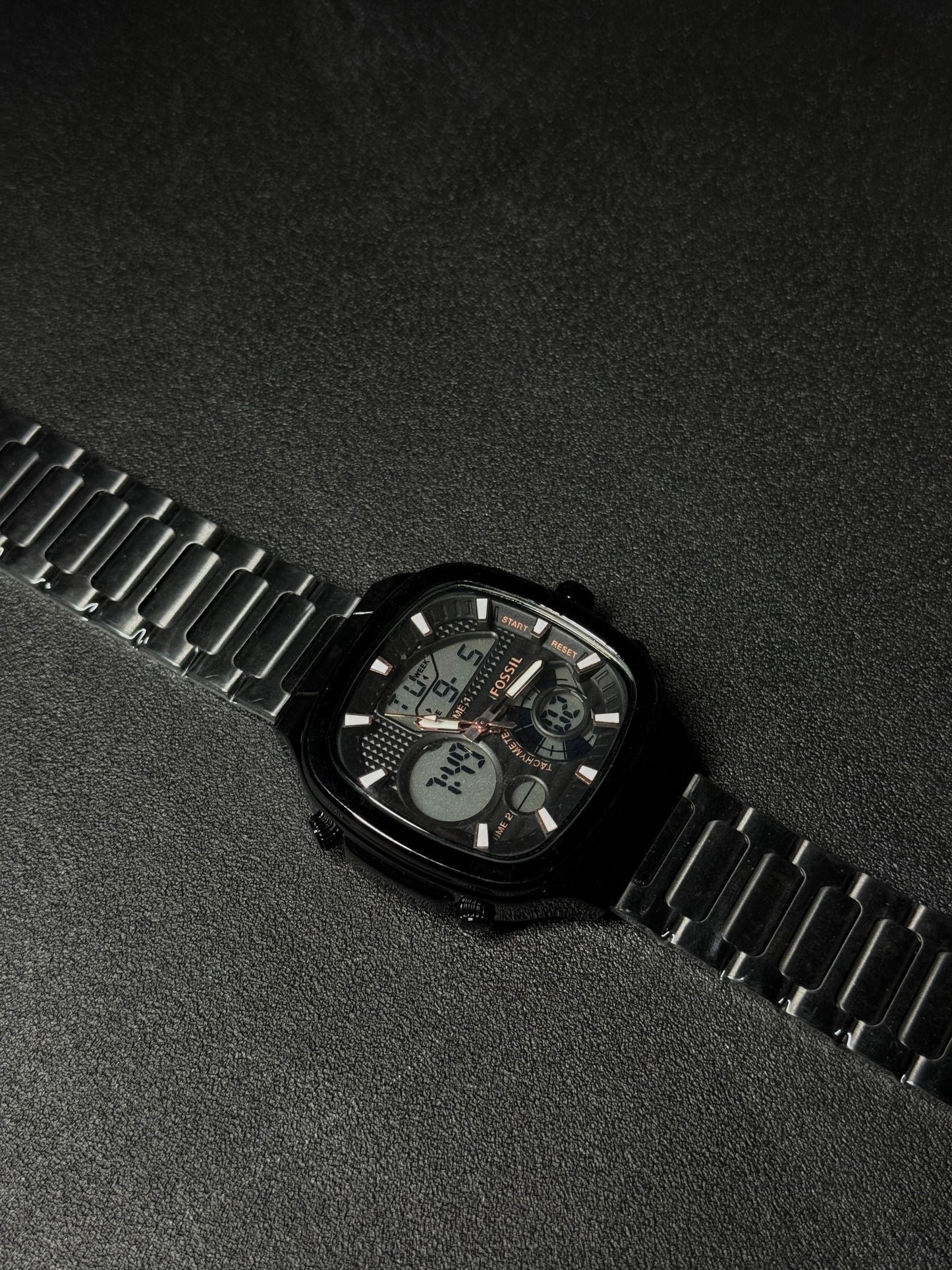 Black stainless steel replica watch with dual analog-digital display, square case design, luxury metal strap, premium men's fashion wristwatch on dark textured background