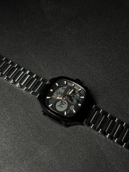 Black stainless steel replica watch with dual analog-digital display, square case design, luxury metal strap, premium men's fashion wristwatch on dark textured background