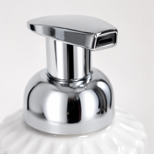 Close-up of chrome pump head on White Ribbed Soap Pump Bottle, smooth dispensing nozzle with premium metallic finish for bathroom soap dispenser
