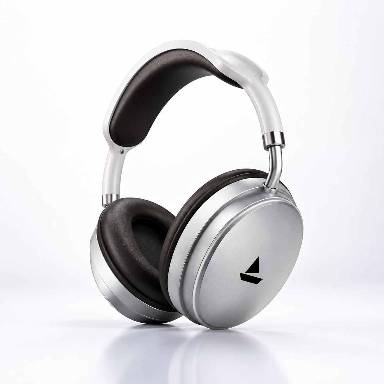Macro close-up of the metallic silver ear cup on premium wireless Bluetooth headphones featuring a minimalist finish, soft over-ear cushioning, durable construction, and modern ergonomic design.