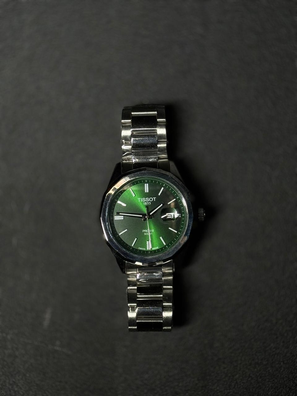 Green dial replica watch with stainless steel bracelet, luxury analog display, men's premium fashion wristwatch on dark textured background